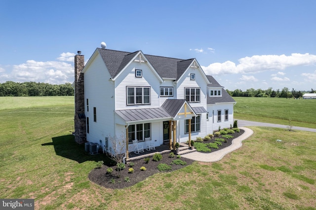 3471 Bullfrog Rd, Taneytown, MD 21787 - view of front of home with a standing seam roof, covered porch, a front yard, a chimney, and metal roof