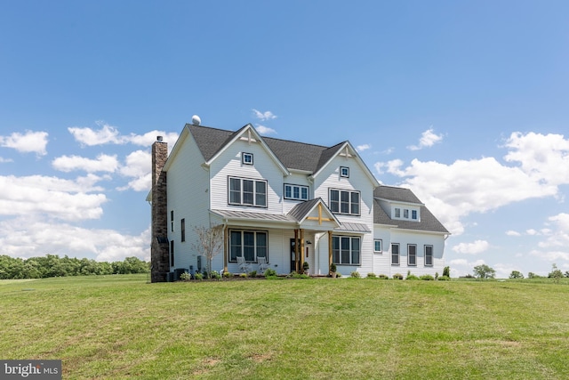 3471 Bullfrog Rd, Taneytown, MD 21787 - view of front of house with a standing seam roof, a front lawn, a chimney, metal roof, and central AC unit