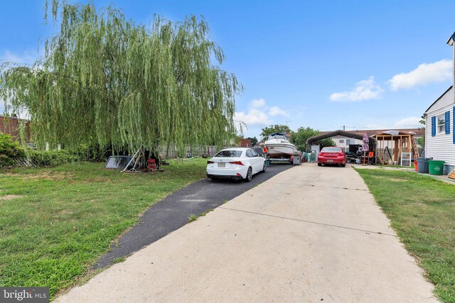 1059 N 32nd St, Camden, NJ 08105 - view of front of house with concrete driveway, a front yard, and a carport