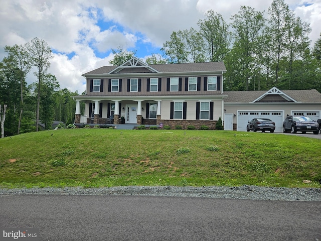 view of front of home featuring a porch, a front lawn, a garage, and stone siding