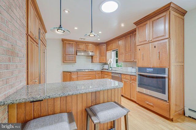 3404 Rustic Way Ln, Falls Church, VA 22044 - kitchen with appliances with stainless steel finishes, under cabinet range hood, a peninsula, light stone countertops, and light wood-style flooring