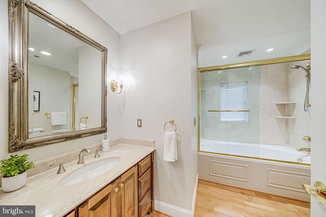 3404 Rustic Way Ln, Falls Church, VA 22044 - full bathroom with vanity, wood finished floors, shower / bath combination with glass door, baseboards, and recessed lighting