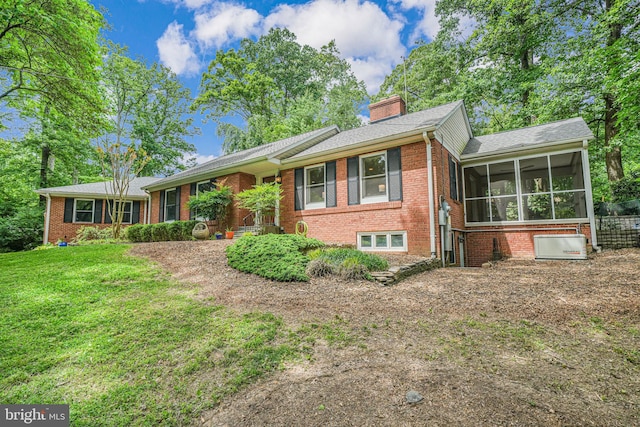 3404 Rustic Way Ln, Falls Church, VA 22044 - view of front facade featuring a sunroom, brick siding, a chimney, and a front lawn