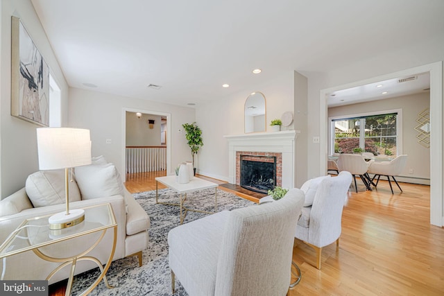 3404 Rustic Way Ln, Falls Church, VA 22044 - living room featuring light wood-style flooring, a fireplace, and recessed lighting