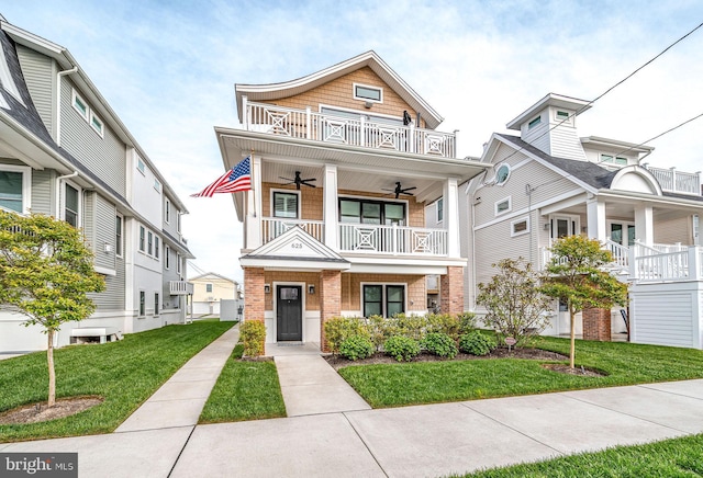 625 Bay Ave, Ocean City, NJ 08226 - view of front of property featuring a balcony, a ceiling fan, a front lawn, and brick siding