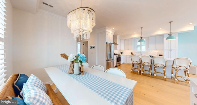 625 Bay Ave, Ocean City, NJ 08226 - dining space featuring a chandelier, light wood-style floors, recessed lighting, and crown molding