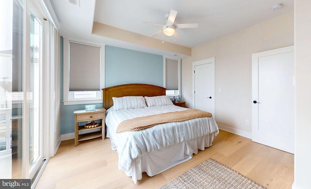 625 Bay Ave, Ocean City, NJ 08226 - bedroom with light wood-style floors, multiple windows, baseboards, and a ceiling fan
