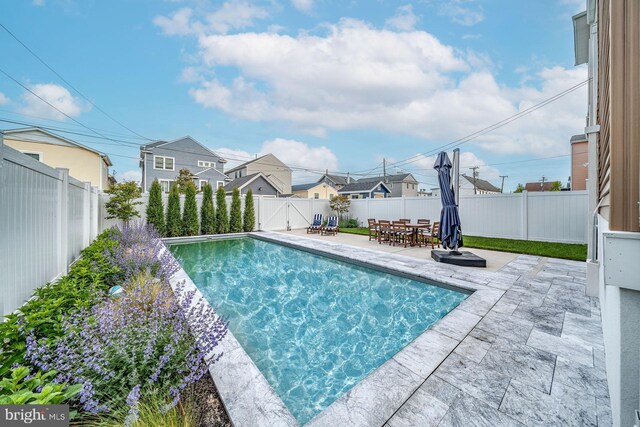 625 Bay Ave, Ocean City, NJ 08226 - view of swimming pool with a patio, a fenced backyard, a residential view, and outdoor dining space