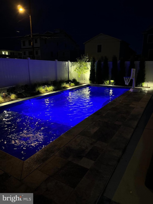 625 Bay Ave, Ocean City, NJ 08226 - pool at twilight featuring a fenced backyard and a patio