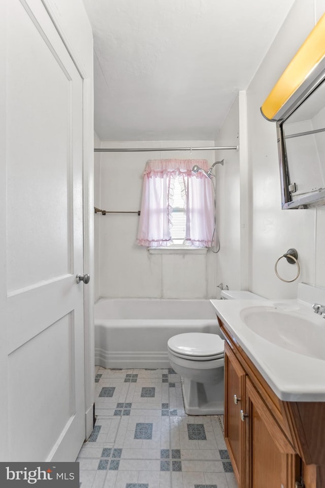 bathroom featuring toilet, vanity, tub / shower combination, and tile patterned flooring
