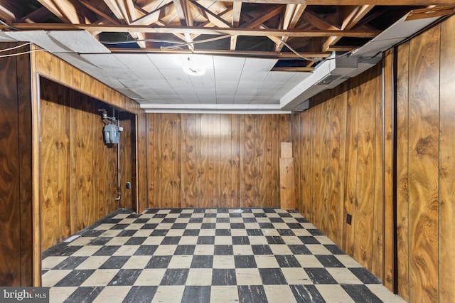 finished basement with wooden walls and dark floors