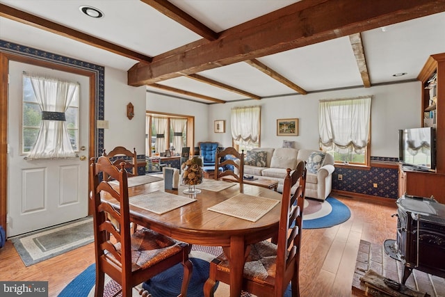 dining room featuring hardwood / wood-style flooring and beam ceiling