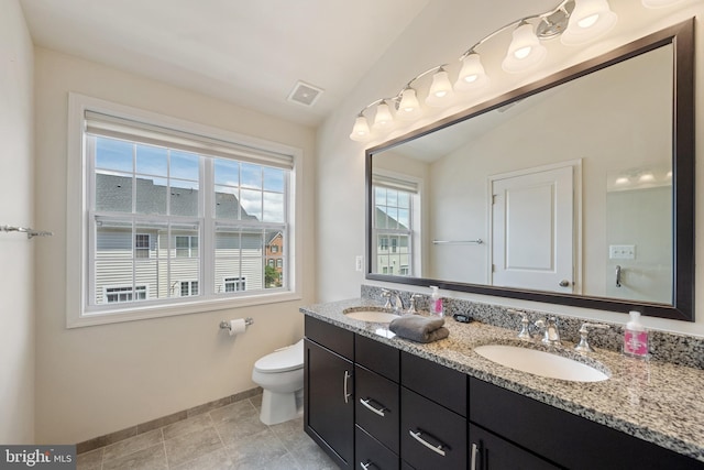 43008 Paris Gap Sq, Ashburn, VA 20148 - bathroom featuring baseboards, toilet, double vanity, and vaulted ceiling