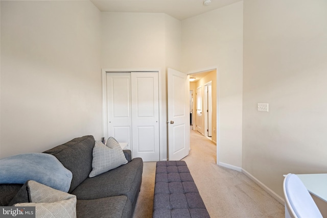 43008 Paris Gap Sq, Ashburn, VA 20148 - living area featuring light carpet, a high ceiling, and baseboards