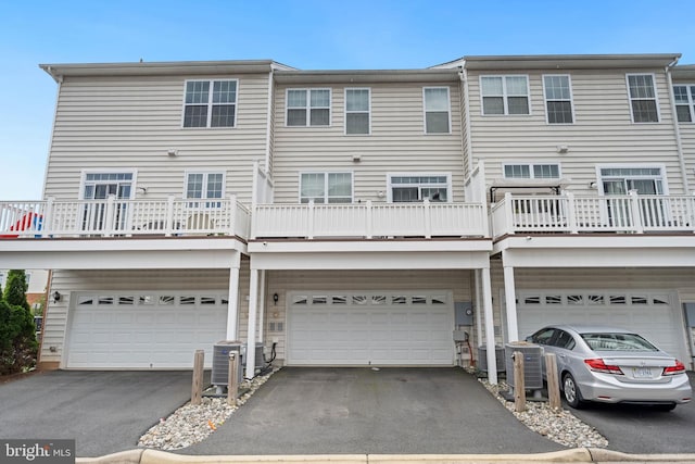 43008 Paris Gap Sq, Ashburn, VA 20148 - back of property with a garage, driveway, and cooling unit