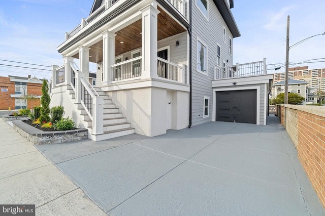 101 S Baton Rouge Ave, Ventnor City, NJ 08406 - view of side of property featuring concrete driveway, a garage, covered porch, and stairs