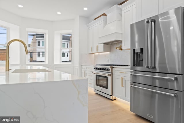 101 S Baton Rouge Ave, Ventnor City, NJ 08406 - kitchen featuring high end appliances, custom exhaust hood, white cabinets, recessed lighting, and light wood-style floors