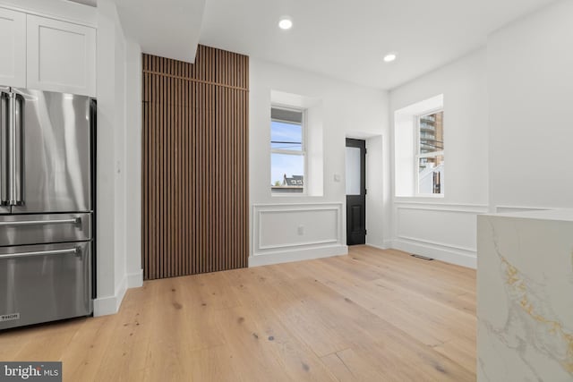 101 S Baton Rouge Ave, Ventnor City, NJ 08406 - kitchen with freestanding refrigerator, light wood-style flooring, white cabinets, recessed lighting, and a decorative wall