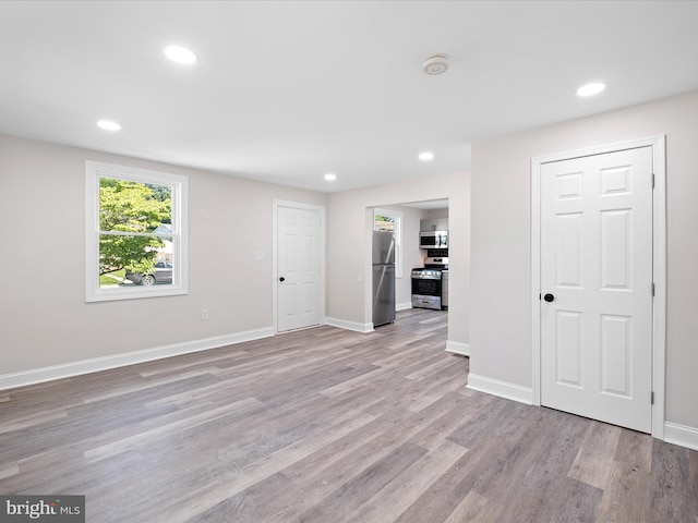 115 Buck Ln, New Castle, DE 19720 - unfurnished living room with light wood-type flooring, recessed lighting, and baseboards