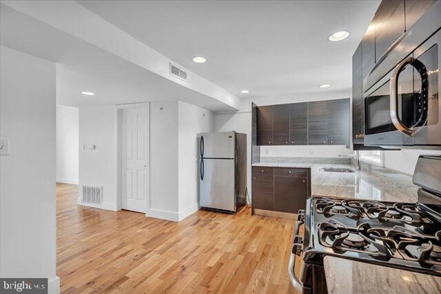 1014 N 4th St, Philadelphia, PA 19123 - kitchen with stainless steel appliances, light wood-type flooring, light stone countertops, and recessed lighting