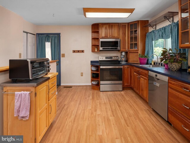 3357 Old Line Ave, Laurel, MD 20724 - kitchen with appliances with stainless steel finishes, a sink, open shelves, light wood-style floors, and dark countertops
