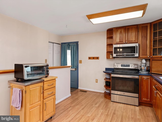 3357 Old Line Ave, Laurel, MD 20724 - kitchen with stainless steel appliances, open shelves, light wood-style floors, dark countertops, and brown cabinetry