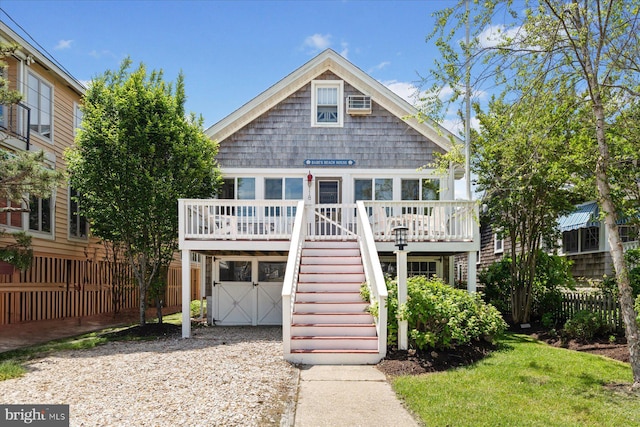 118 Parkwood St, Bethany Beach, DE 19930 - raised beach house with stairway, a deck, an attached garage, and driveway