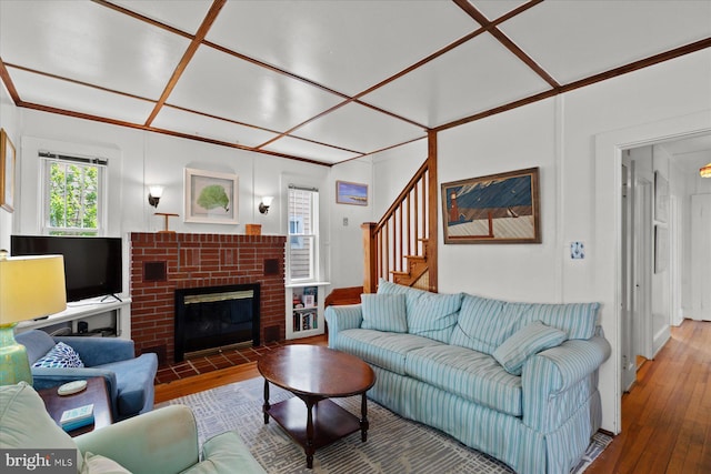118 Parkwood St, Bethany Beach, DE 19930 - living room featuring hardwood / wood-style flooring, stairway, and a brick fireplace