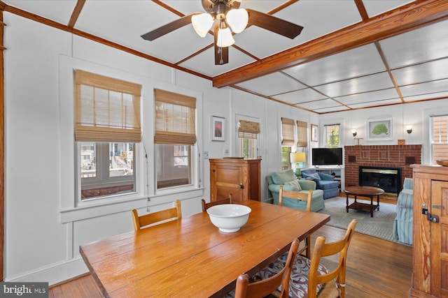 118 Parkwood St, Bethany Beach, DE 19930 - dining room featuring hardwood / wood-style floors, ceiling fan, and a fireplace