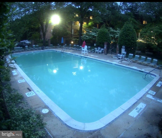 community pool with a patio area