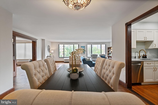 2501 Calvert St NW Unit 306, Washington, DC 20008 - dining space featuring wood finished floors, baseboards, and wet bar
