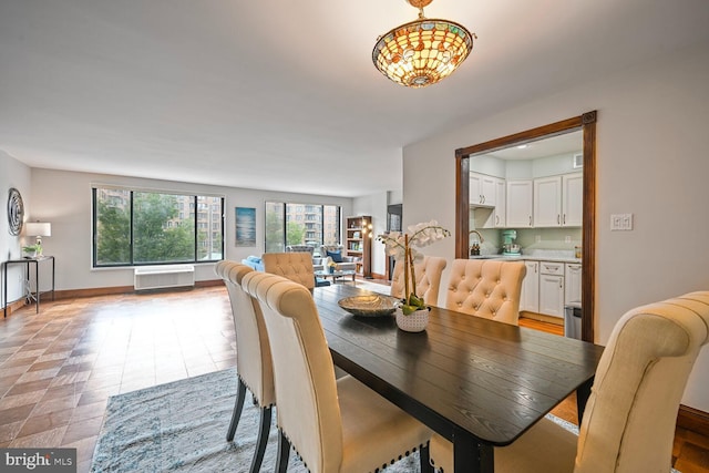 2501 Calvert St NW Unit 306, Washington, DC 20008 - dining space featuring an AC wall unit and baseboards