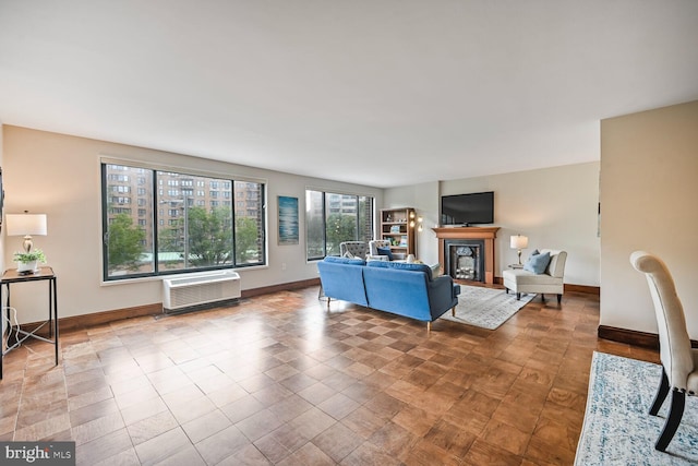 2501 Calvert St NW Unit 306, Washington, DC 20008 - living area featuring an AC wall unit, baseboards, and a glass covered fireplace