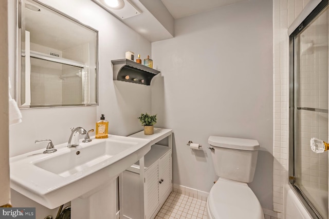 2501 Calvert St NW Unit 306, Washington, DC 20008 - bathroom featuring toilet, tile patterned flooring, shower / bath combination with glass door, a sink, and baseboards
