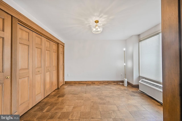 2501 Calvert St NW Unit 306, Washington, DC 20008 - unfurnished dining area featuring baseboards and a wall mounted AC