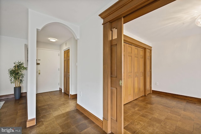 2501 Calvert St NW Unit 306, Washington, DC 20008 - hall with arched walkways, baseboards, and dark floors