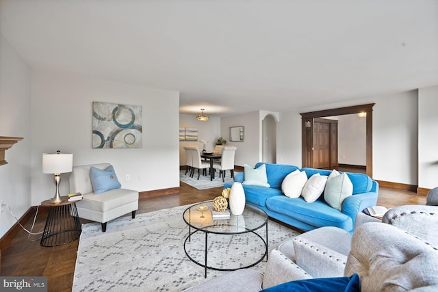 2501 Calvert St NW Unit 306, Washington, DC 20008 - living room featuring baseboards and arched walkways