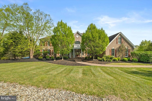 217 Rising Meadow Way E, Stroudsburg, PA 18302 - view of front of property featuring a front lawn, brick siding, and a balcony