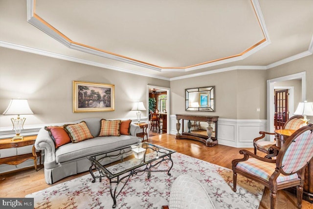 217 Rising Meadow Way E, Stroudsburg, PA 18302 - living area featuring a raised ceiling, wood finished floors, a wainscoted wall, and crown molding