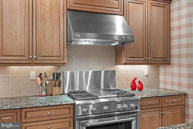 217 Rising Meadow Way E, Stroudsburg, PA 18302 - kitchen featuring under cabinet range hood, brown cabinetry, backsplash, and stainless steel range