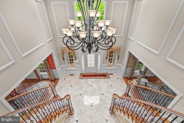 217 Rising Meadow Way E, Stroudsburg, PA 18302 - entrance foyer with healthy amount of natural light, a chandelier, a high ceiling, stairway, and a decorative wall