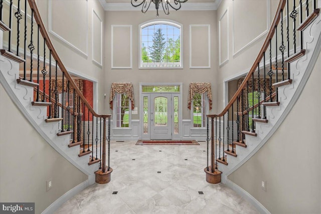 217 Rising Meadow Way E, Stroudsburg, PA 18302 - foyer entrance with crown molding, a towering ceiling, stairway, a chandelier, and baseboards
