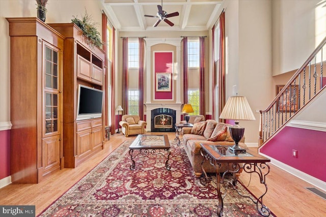 217 Rising Meadow Way E, Stroudsburg, PA 18302 - living area featuring light wood finished floors, baseboards, stairs, a ceiling fan, and beam ceiling