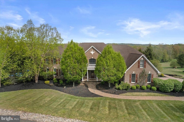 217 Rising Meadow Way E, Stroudsburg, PA 18302 - georgian-style home featuring brick siding and a front yard
