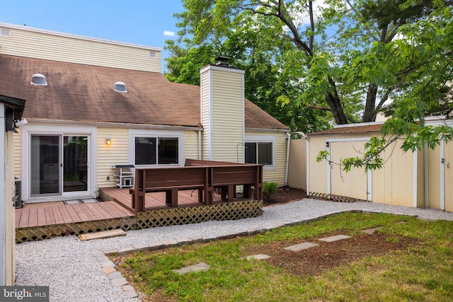 370 Juniper Ct, Herndon, VA 20170 - back of property with a wooden deck, a chimney, an outbuilding, and a shingled roof