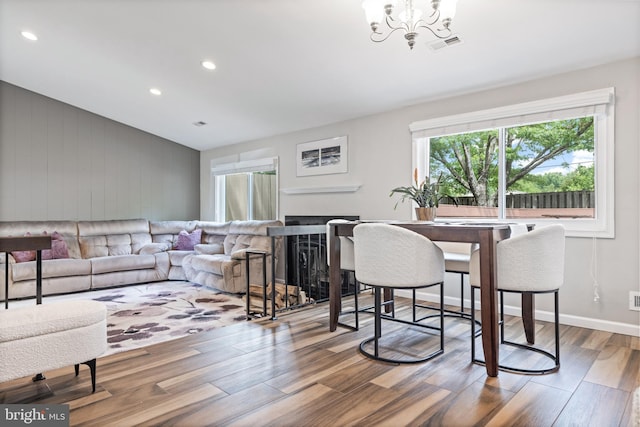 370 Juniper Ct, Herndon, VA 20170 - dining area with wood finished floors, vaulted ceiling, a chandelier, recessed lighting, and a fireplace