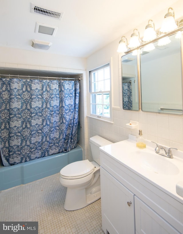 7 Hatsawap Rd, Cambridge, MD 21613 - bathroom featuring tile patterned floors, vanity, toilet, shower / bath combination with curtain, and tile walls