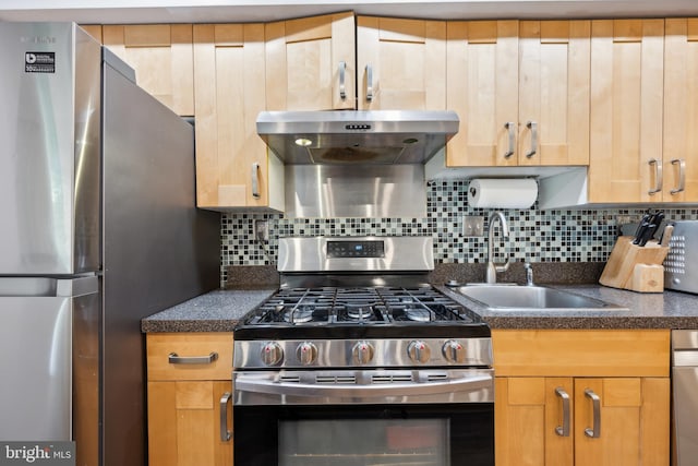 kitchen with appliances with stainless steel finishes, a sink, ventilation hood, backsplash, and light brown cabinetry