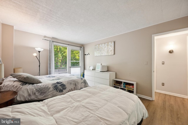 bedroom featuring light wood-type flooring and baseboards