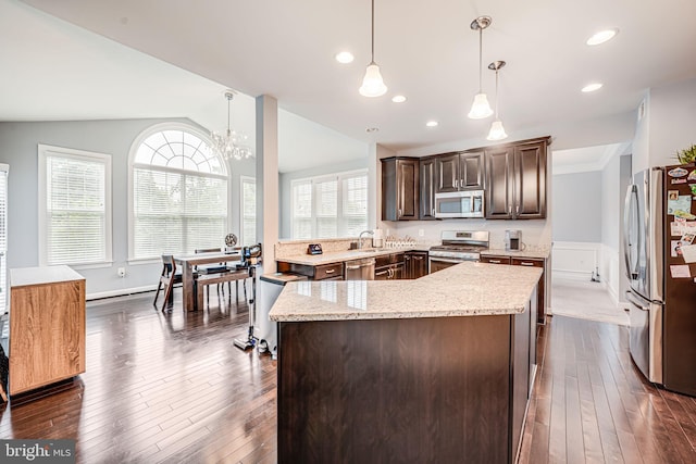 3104 Reach Eagle Ct, Woodbridge, VA 22191 - kitchen featuring stainless steel appliances, a kitchen island, dark brown cabinets, lofted ceiling, and a sink